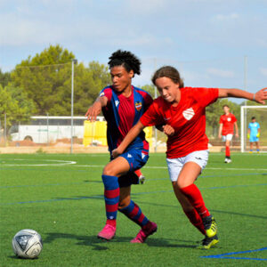 Ava challenging player for ball