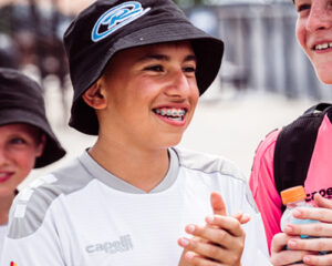 boy smiling and clapping at rush fest